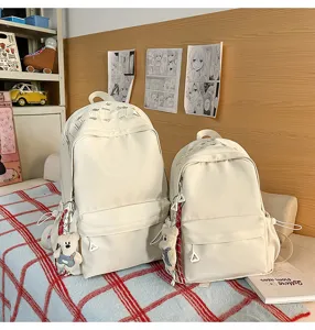 Casual solid color college backpack set with cute bear pendant for daily commute and travel.