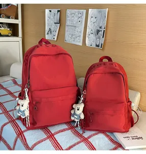 Detailed view of cute solid color casual backpacks with bear pendants for daily commute.