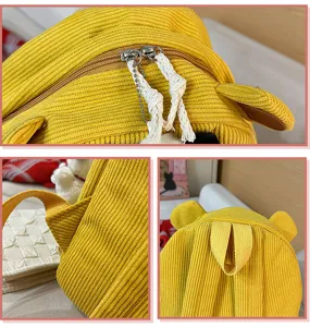 Cute yellow corduroy backpack detail shot with bear ears and durable zipper design.