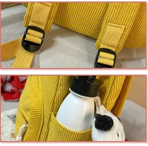 Corduroy backpack detail shot showing adjustable shoulder straps and side pocket with bottle.