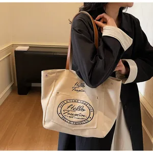 Vue détaillée du cabas en toile décontracté pour femmes, sac bandoulière élégant poignée marron.