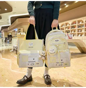 Cute yellow polka dot school backpack and tote bag set with bear pendants for students.