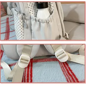Side pocket and shoulder buckle detail view of the casual polka dot student backpack.