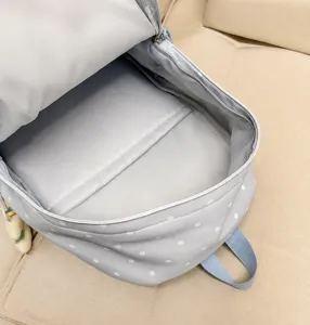 Light blue polka dot backpack interior detail showing spacious main compartment and laptop sleeve.