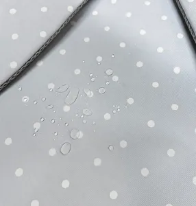 Close up of waterproof grey fabric with white polka dots for backpack material details.