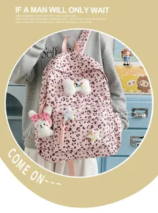 Detailed view of the pink leopard print backpack with cute plush bunny and star charms.