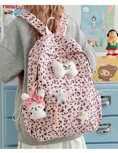 Cute pink leopard print backpack with plush charms, stylish Japanese sweet style school bag.