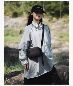Casual crossbody bag detail view, featuring compact utility design and adjustable strap.