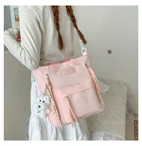 Sac à bandoulière en toile rose avec broderie nœud, pendentif chiot et grande capacité.