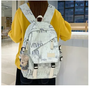 Niche street style canvas backpack with trendy print and cute pendant for daily student use.