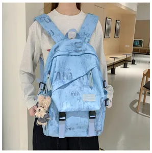 Detailed view of the stylish light blue student backpack featuring cute plush keychain and pockets.