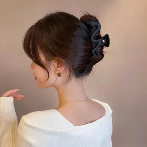 Large matte wavy hair claw clip for women, stylish shark hair clip, elegant hair accessory.