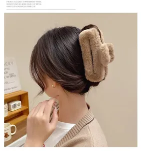 Oversized plush hair claw clip for women, cute winter fuzzy shark clip hair accessory.