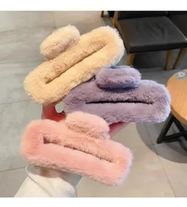 Closeup detail shot of oversized plush hair claws in multi-colors like pink and purple.