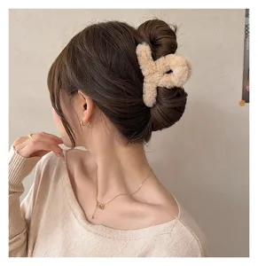 Close-up detail of fluffy beige plush hair claw clip, soft faux fur texture for autumn.