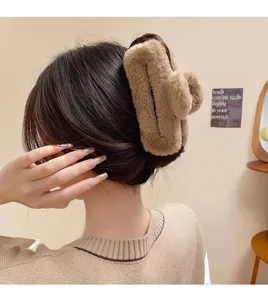Oversized fluffy hair claw clip for women, plush brown shark clip, cozy autumn winter accessory.