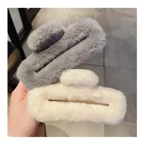 Oversized plush hair claw detail shot, soft fluffy winter hair accessory in grey.