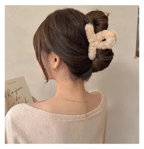 Fuzzy plush hair claw clip for women, cute winter hair accessories for styling updos.