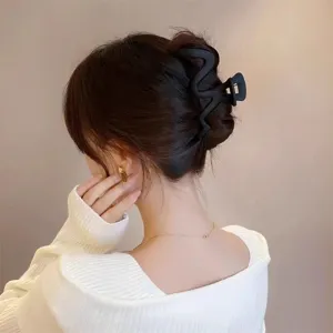 Matte wavy hair claw clip for women, large nonslip hair accessory for styling back hair.