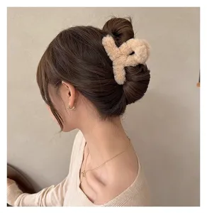 Plush hair claw clip for women, fluffy winter hair catch barrette, soft aesthetic hair accessory.