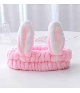 Cute plush bunny ear detail shot, soft pink headband for daily facial washing and makeup.
