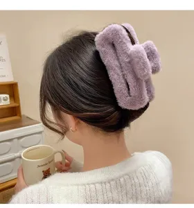 Fluffy large hair claw clip for women, cozy winter plush hair accessory, stylish purple grip.