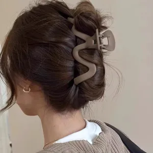 Matte wavy hair claw clip for women, large size hair accessory for styling buns and ponytails.