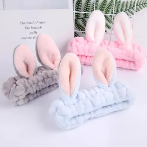 Cute plush bunny ear headband for face washing and makeup, soft winter hair accessory.