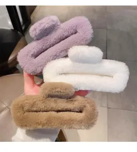 Close-up detail view of fluffy plush hair claws in purple, white, and brown colors.