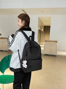 Stylish minimalist black backpack for women and students, large capacity casual daily school bag.