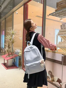 Japanese style light blue campus backpack for students, featuring large capacity and front pocket.