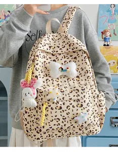Detailed shot of cute leopard print backpack with plush bunny and star charms for daily wear.
