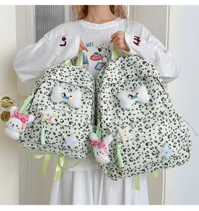 Cute Japanese style light green leopard print backpack with plush rabbit pendant and star decor.