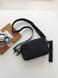 Black casual crossbody bag for men and women, featuring durable fabric and adjustable strap.