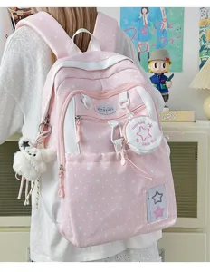 Pink star pattern backpack detail view, cute student schoolbag with pendants and mini pouch.