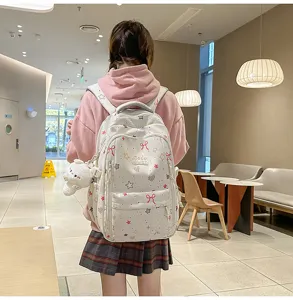 Cute preppy style school backpack with star bow prints and plush pendant for student daily travel.