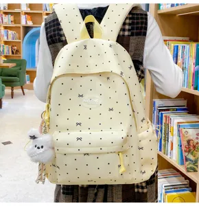 Cute light yellow polka dot school backpack for students, large capacity casual rucksack daily.