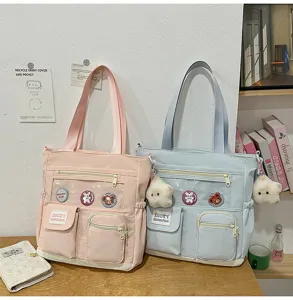 Borsa tote in tela carina con finestra trasparente e tasche per uso scolastico.