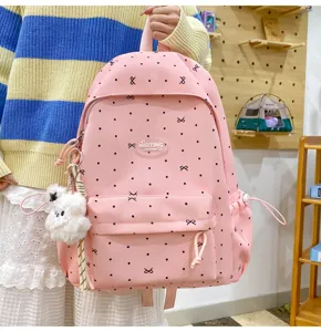 Pink polka dot bow school backpack for girls, cute large capacity casual daypack daily use.