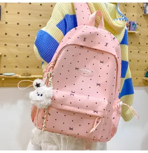 Cute pink polka dot bow backpack detail view featuring soft plush pendant and large capacity.