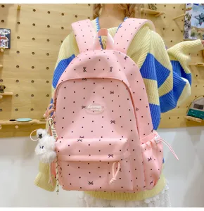 Pink aesthetic school backpack with cute bow prints, large capacity casual daypack for daily use.