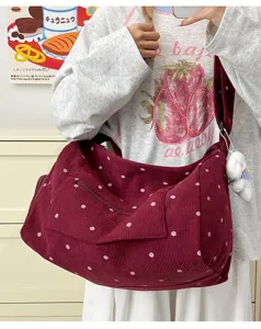 Detail view of retro corduroy polka dot shoulder bag, showcasing soft fabric and casual style.