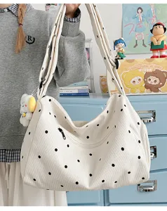 Corduroy polka dot hobo shoulder bag detail shot showing cute bear pendant and soft texture.