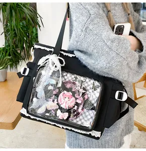 Japanese sweet lolita black ita bag with clear window, bow decor and anime badge display.