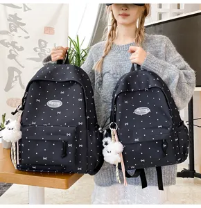 Japanese style minimalist black backpack with cute white dots, bow patterns and bear pendant.