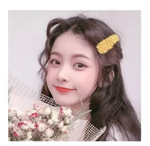 Yellow plush hair clip for women, cute fluffy fuzzy side clip winter hair accessory.