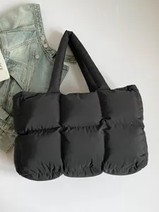 Black quilted puffer tote bag for women, soft cotton-filled cloud pillow underarm handbag.