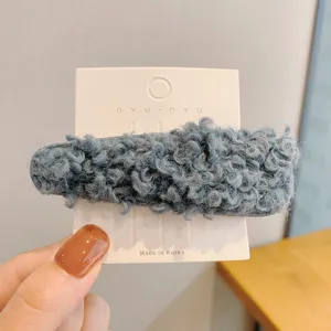 Cozy blue fluffy hair clip for autumn and winter, soft faux shearling side hairpin styling.