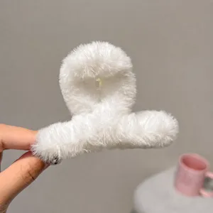 White plush hair claw clip for women, soft faux fur shark clip for sweet autumn winter hairstyles.