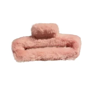 Oversized plush hair claw clip for women, fluffy fuzzy winter hair accessory in pink.